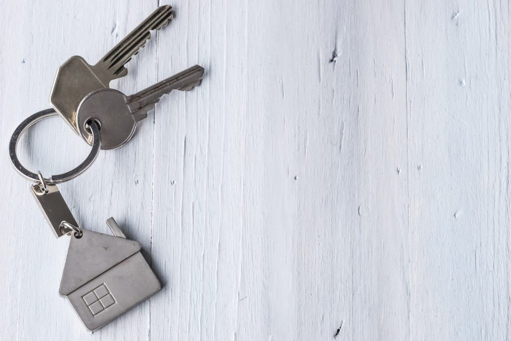 Keys with house keychain representing lease of property