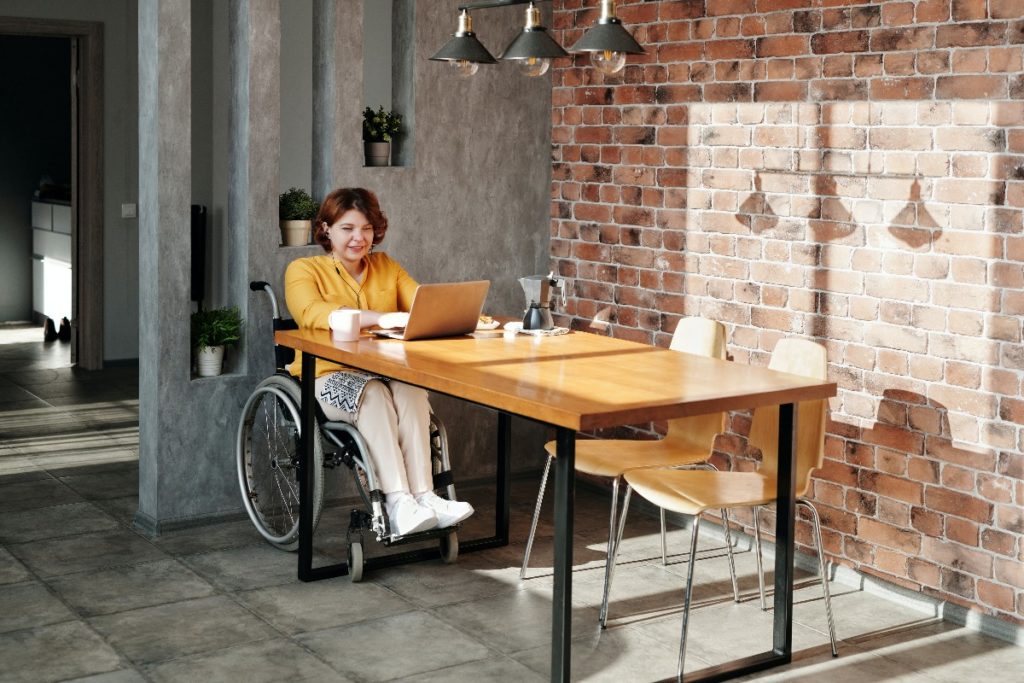 woman on wheelchair using laptop