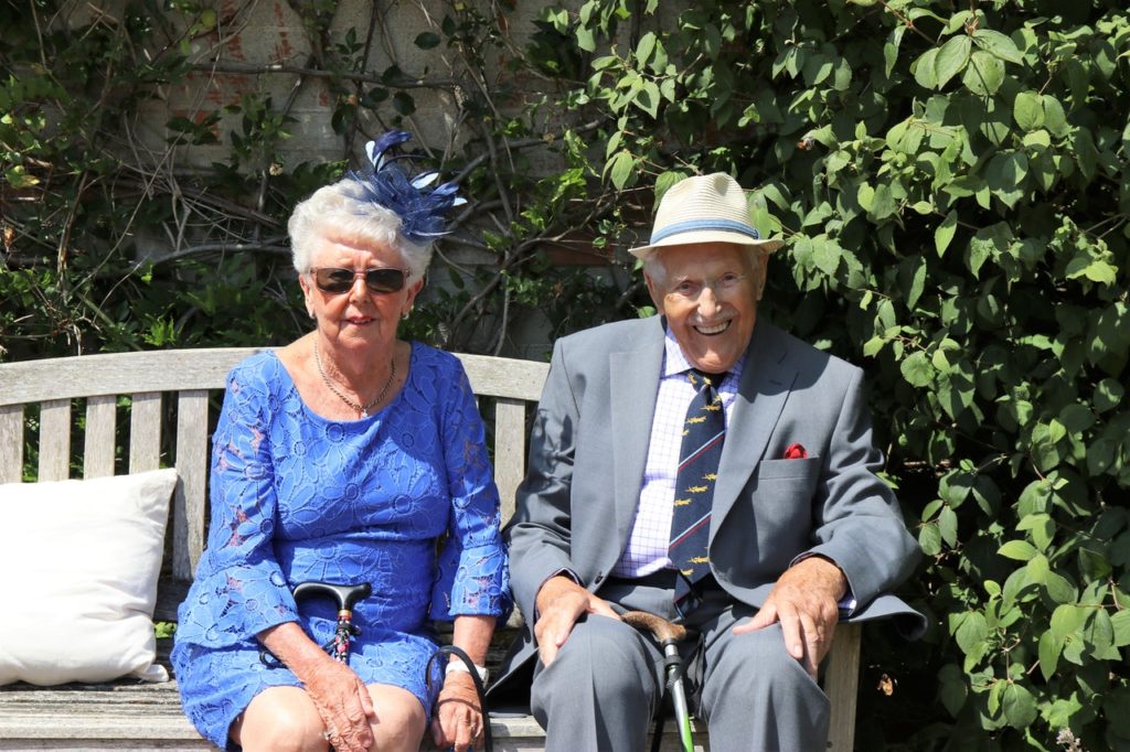 a mature couple sitting on a bench