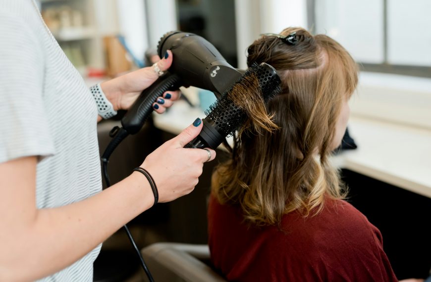 hairdresser blow-drying a client's hair